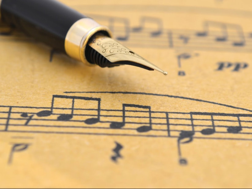 A pen lying on a music score